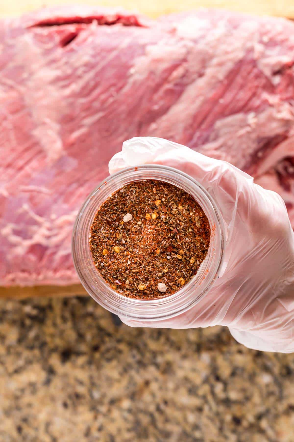 spices in jar, trimmed brisket underneath