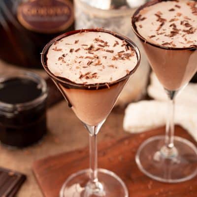 Close up photo of a chocolate martini on a wooden serving board.