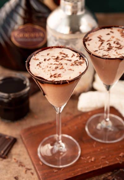 Close up photo of a chocolate martini on a wooden serving board.