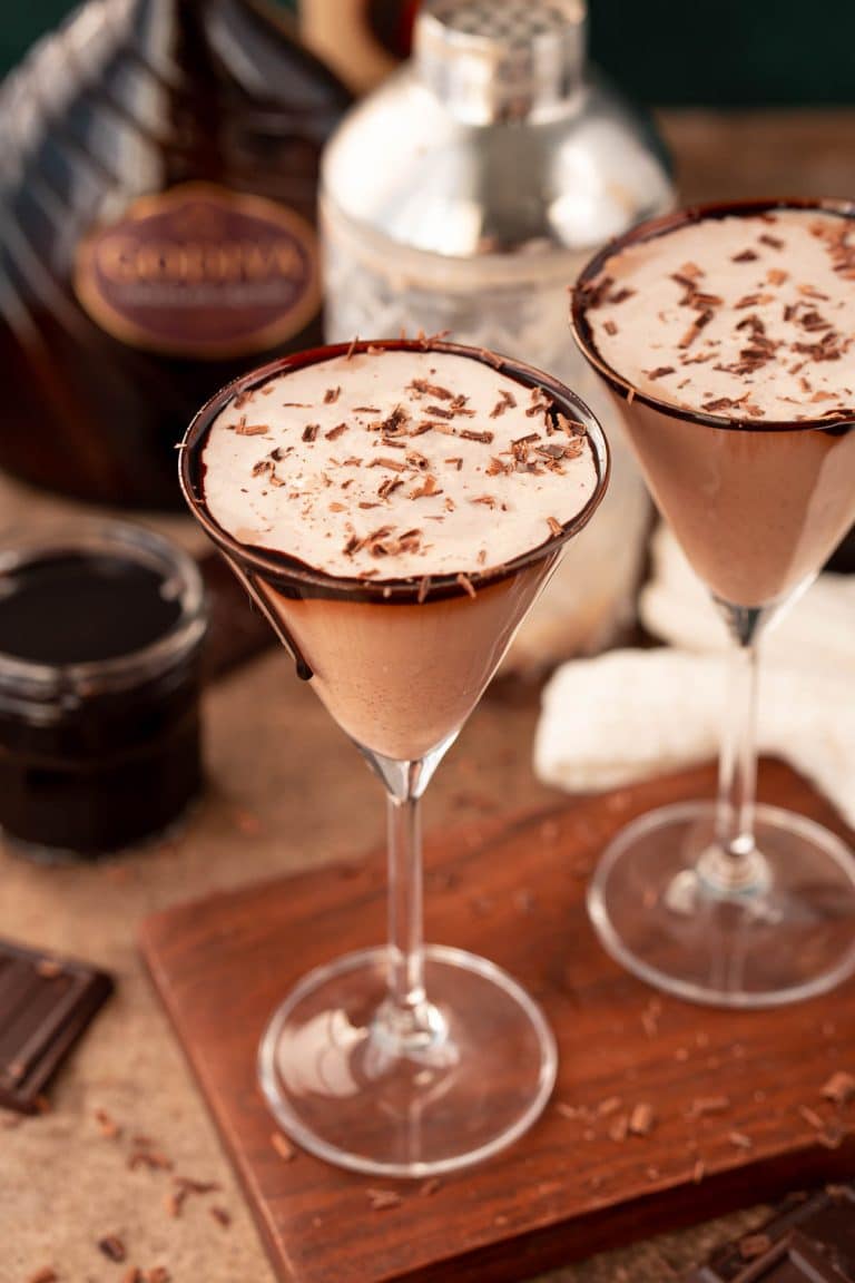 Close up photo of a chocolate martini on a wooden serving board.