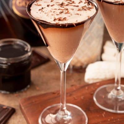 Close up photo of a chocolate martini on a wooden serving board.