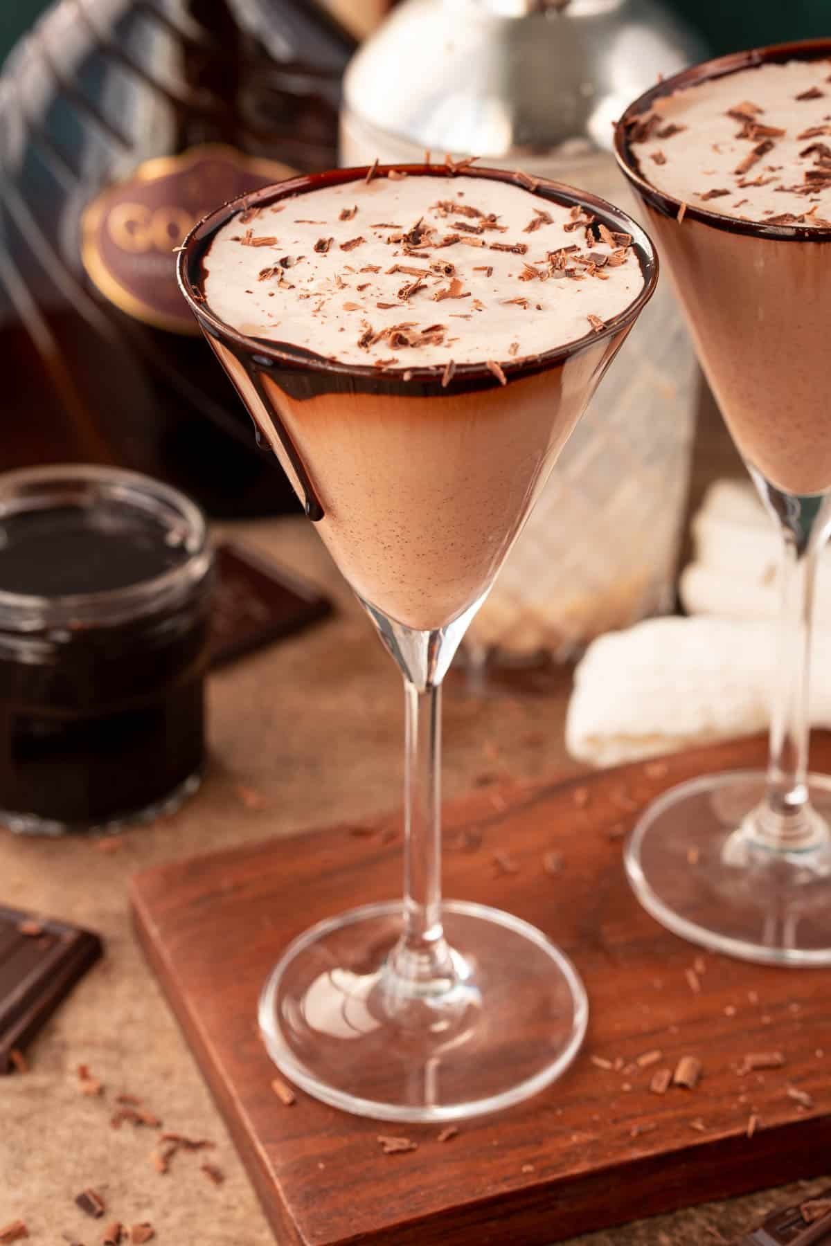 Close up photo of a chocolate martini on a wooden serving board.