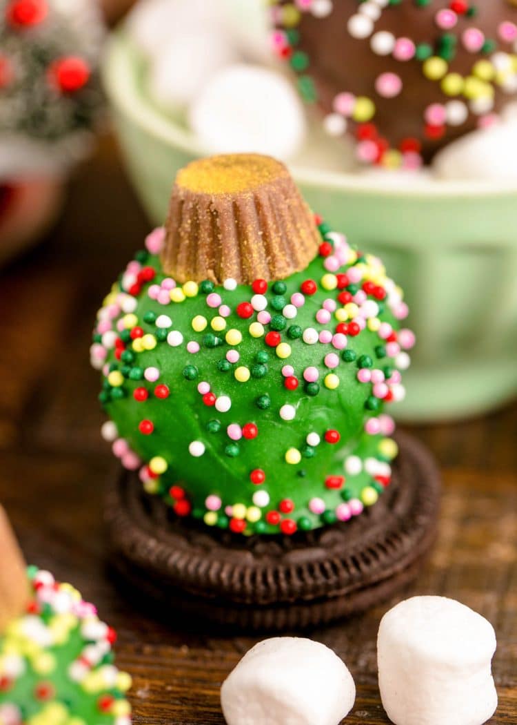 Green colored Oreo Ball Ornament on an oreo.