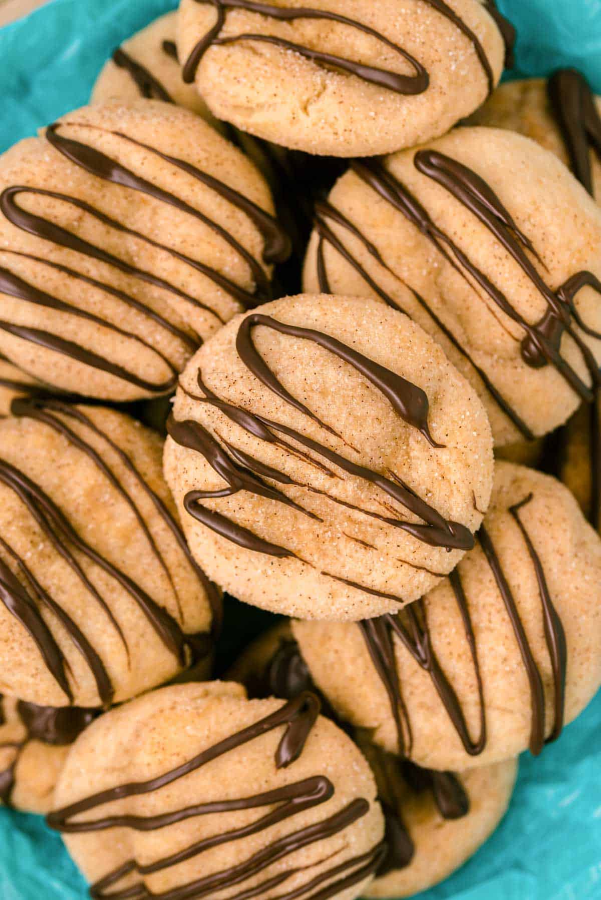 Overhead photo of churro cookies drizzled with chocolate.