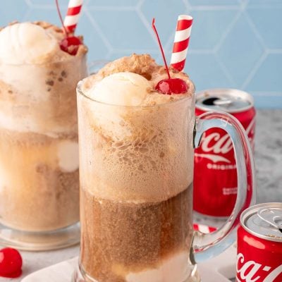 A glass stein filled with a coke float.