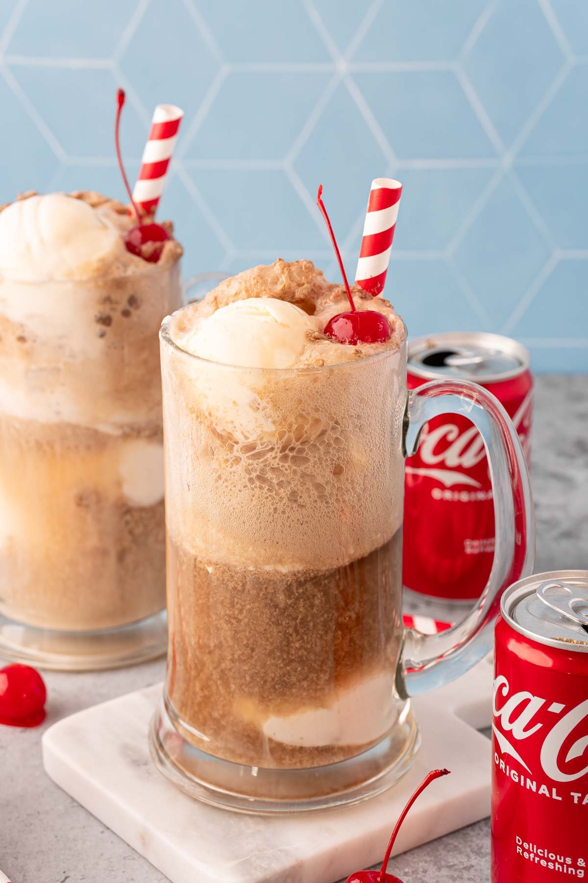 A glass stein filled with a coke float.