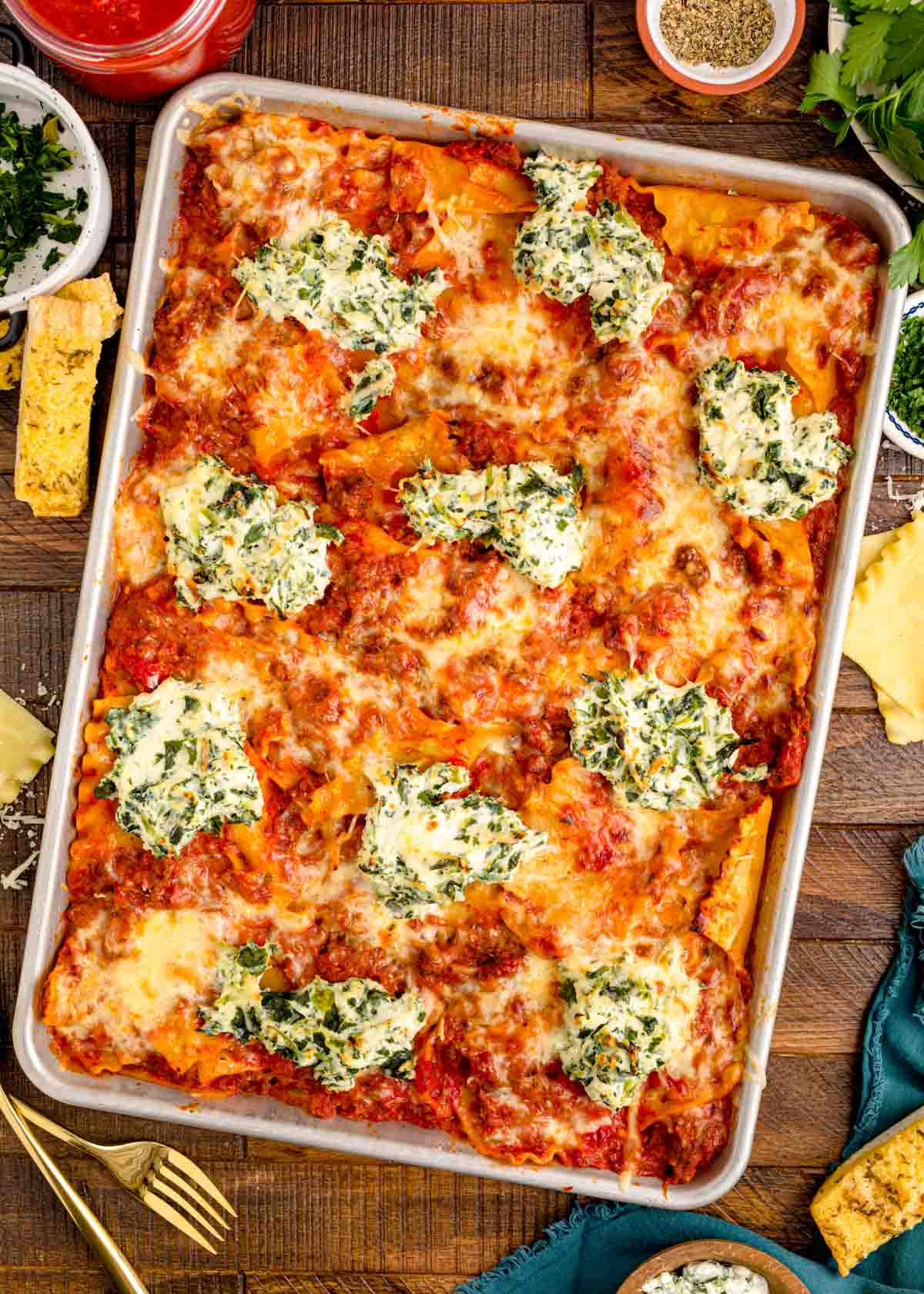 Overhead photo of sheet pan lasagna on a wooden table.