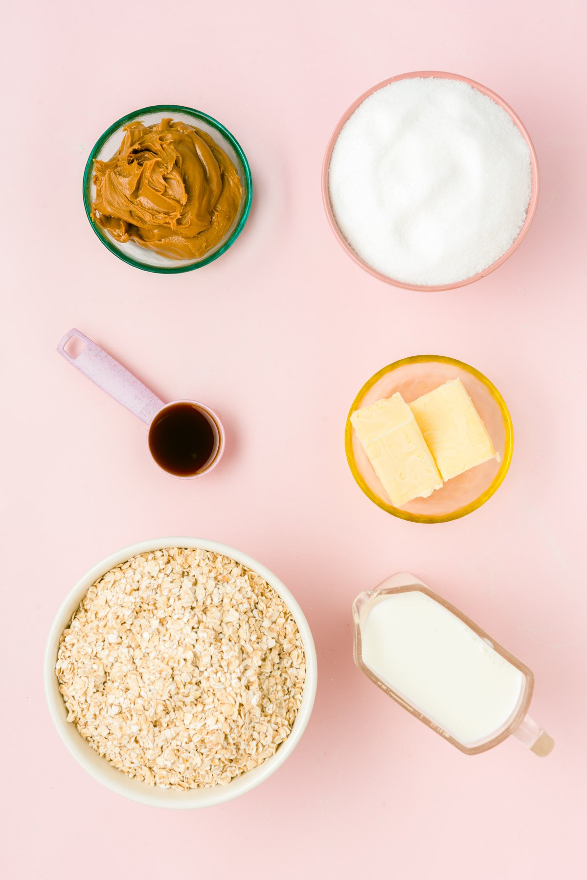 Overhead photo of ingredients to make cookie butter no bake cookies on a pink surface.