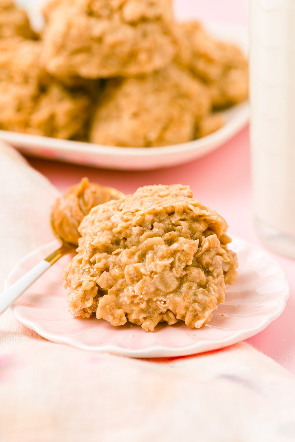 A biscoff cookie butter no bake cookie on a pink plate with a spoon of cookie butter.