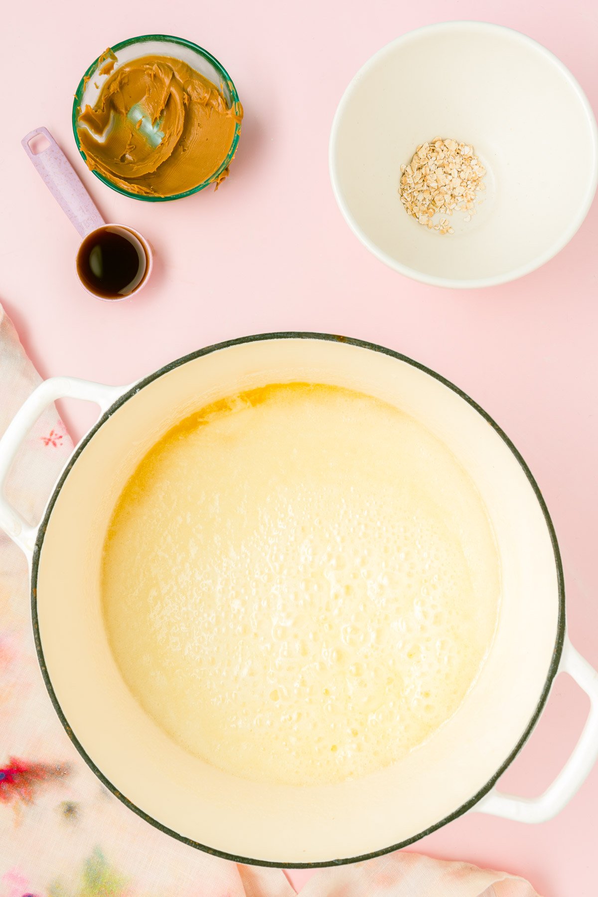 Butter, sugar, and milk boiling in a pot.