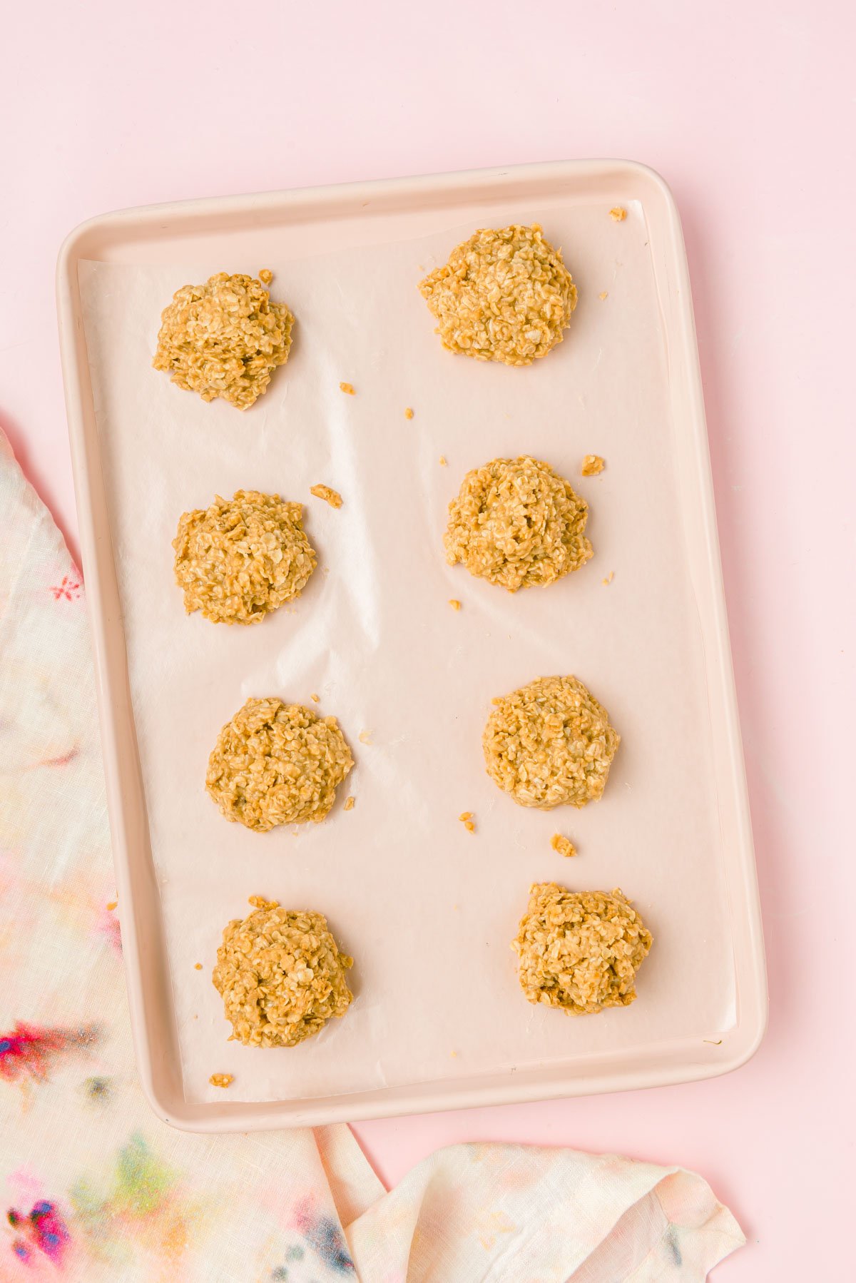 Cookie butter no bake cookies on a wax paper lined baking sheet setting.