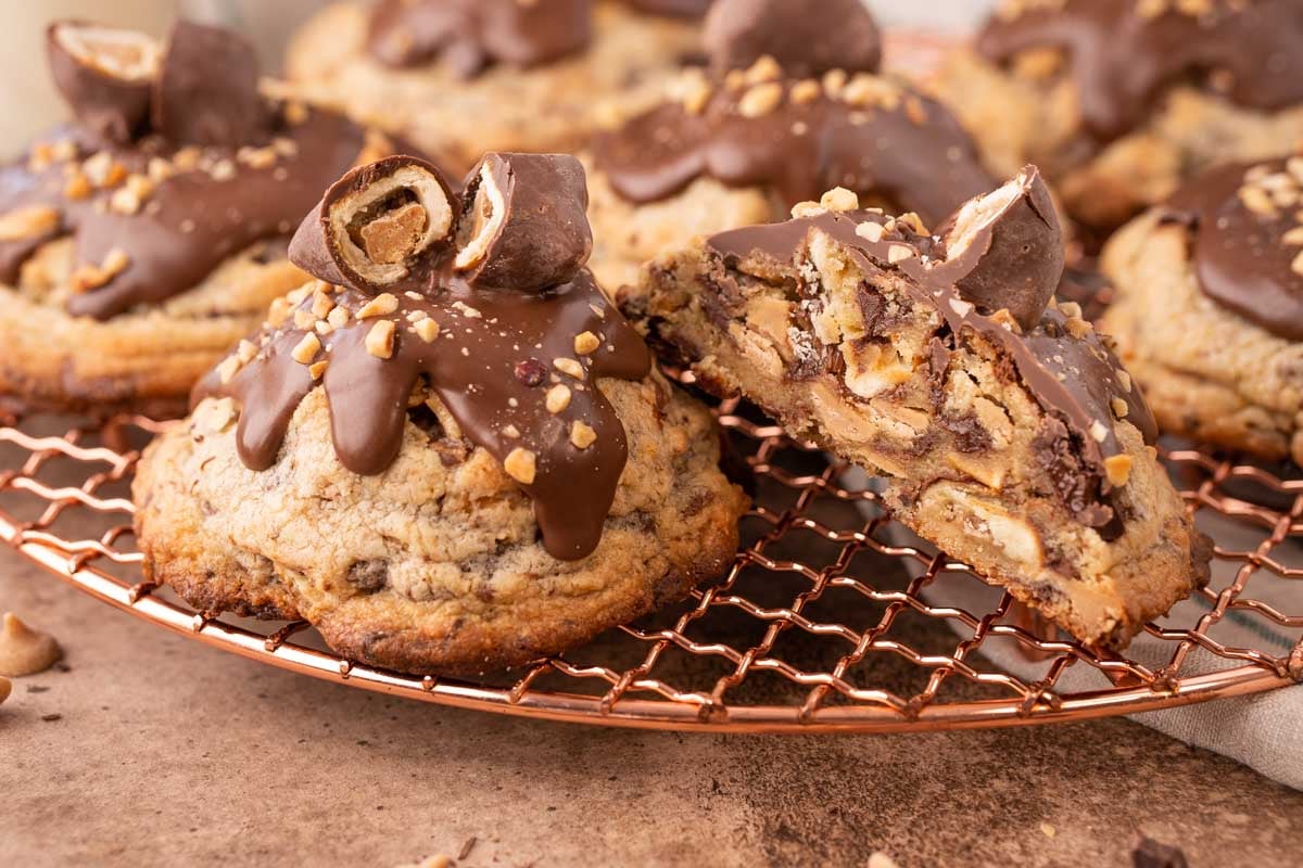 Chubby Hubbell cookies on a copper wire rack, one has been cut in half revealing the inside.