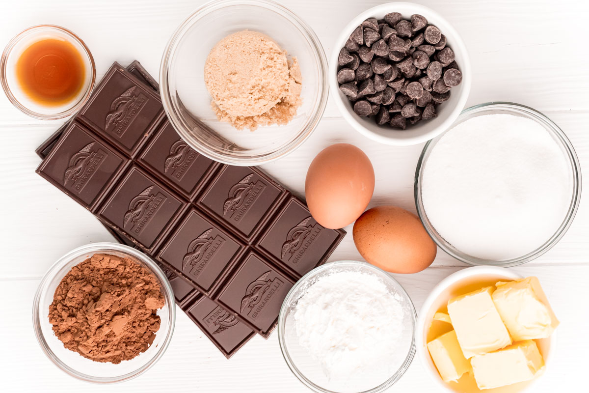 Ingredients on a white table to make flourless brownies.