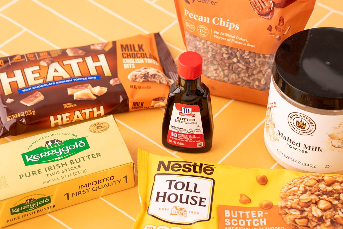 Key ingredients for make butter pecan cookies on a yellow surface.