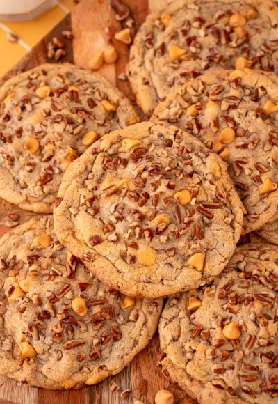 Overhead photo of butter pecan cookies on a wooden serving board.