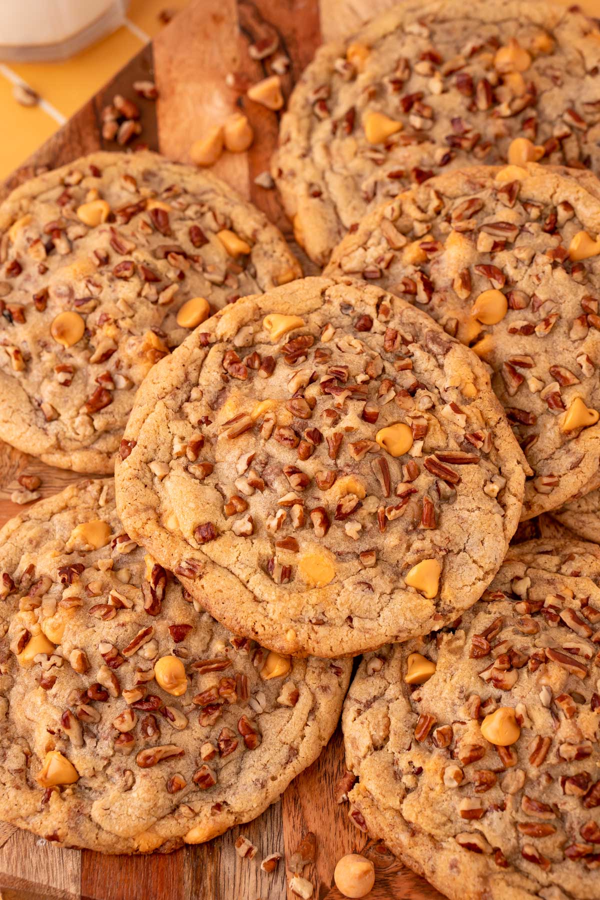 Overhead photo of butter pecan cookies on a wooden serving board.