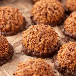 Dulce de Leche macaroons on a pieces of parchment paper.