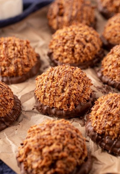 Dulce de Leche macaroons on a pieces of parchment paper.