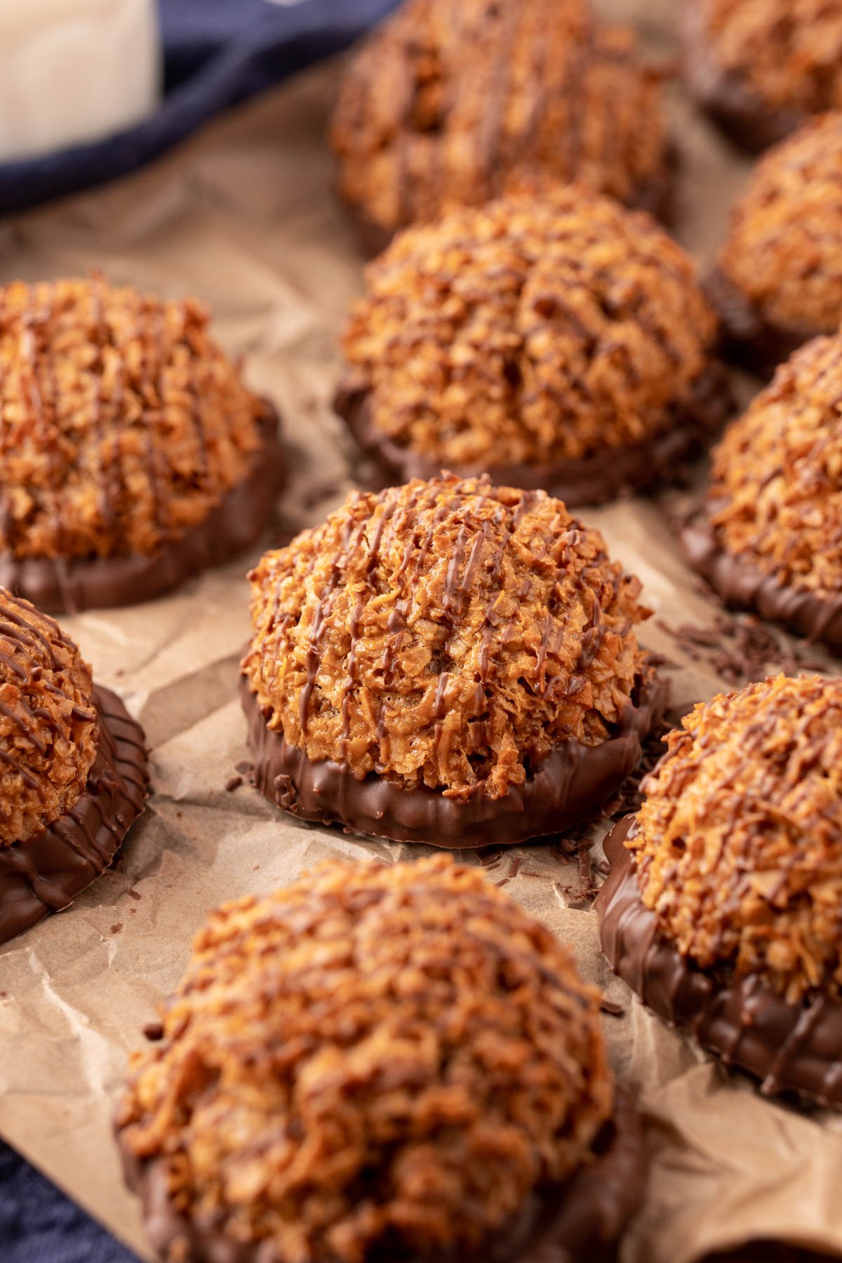 Dulce de Leche macaroons on a pieces of parchment paper.