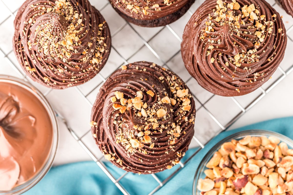 Overhead photo of hazelnut chocolate cupcakes on a wire rack.