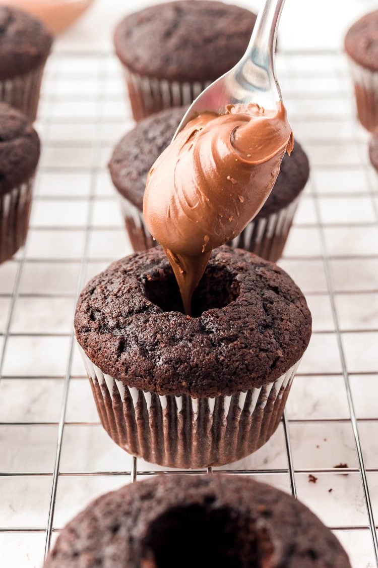 Nutella being added to the core of chocolate cupcakes