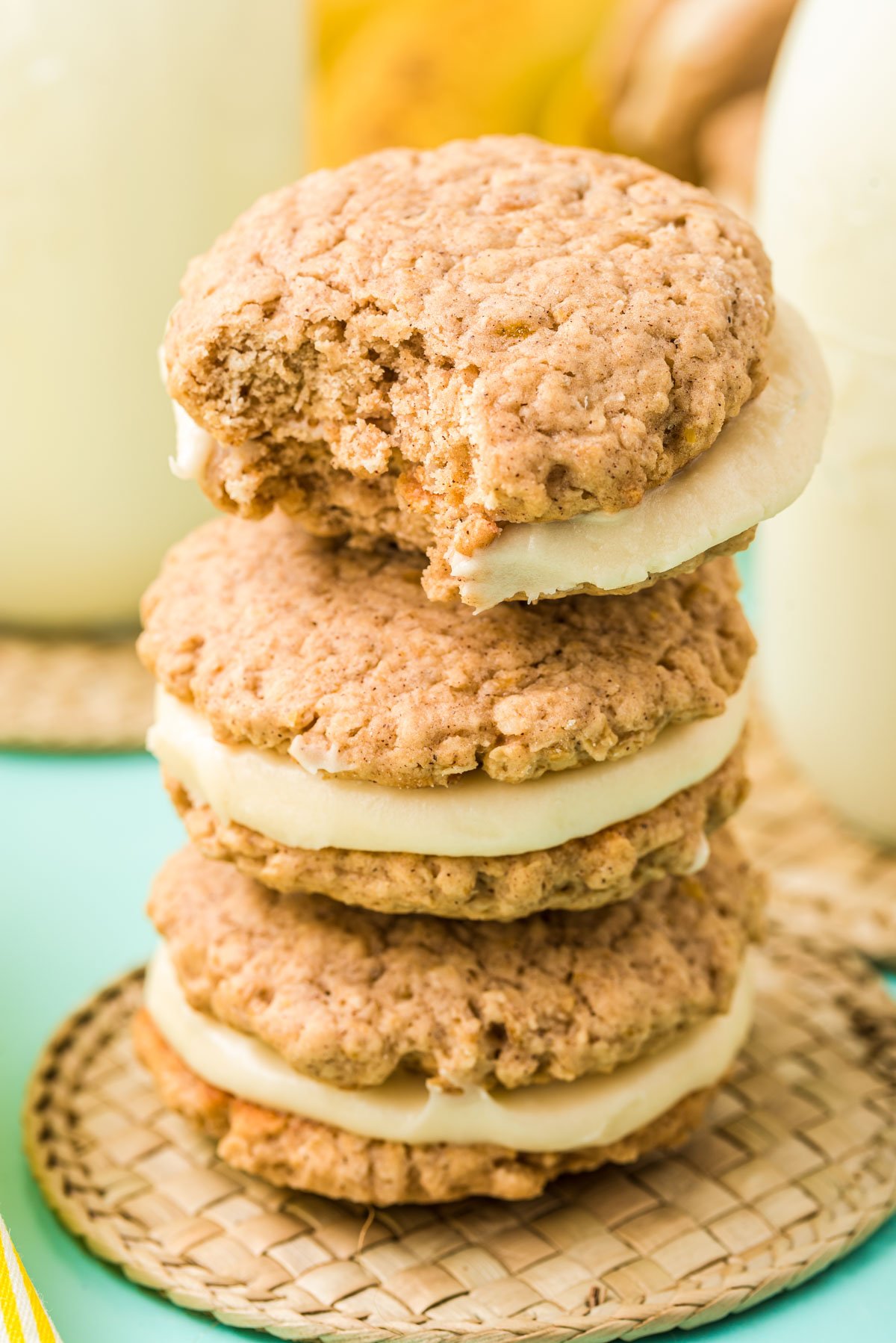 Three banana oatmeal cream pie stacked on top of each other the top one is missing a bite.