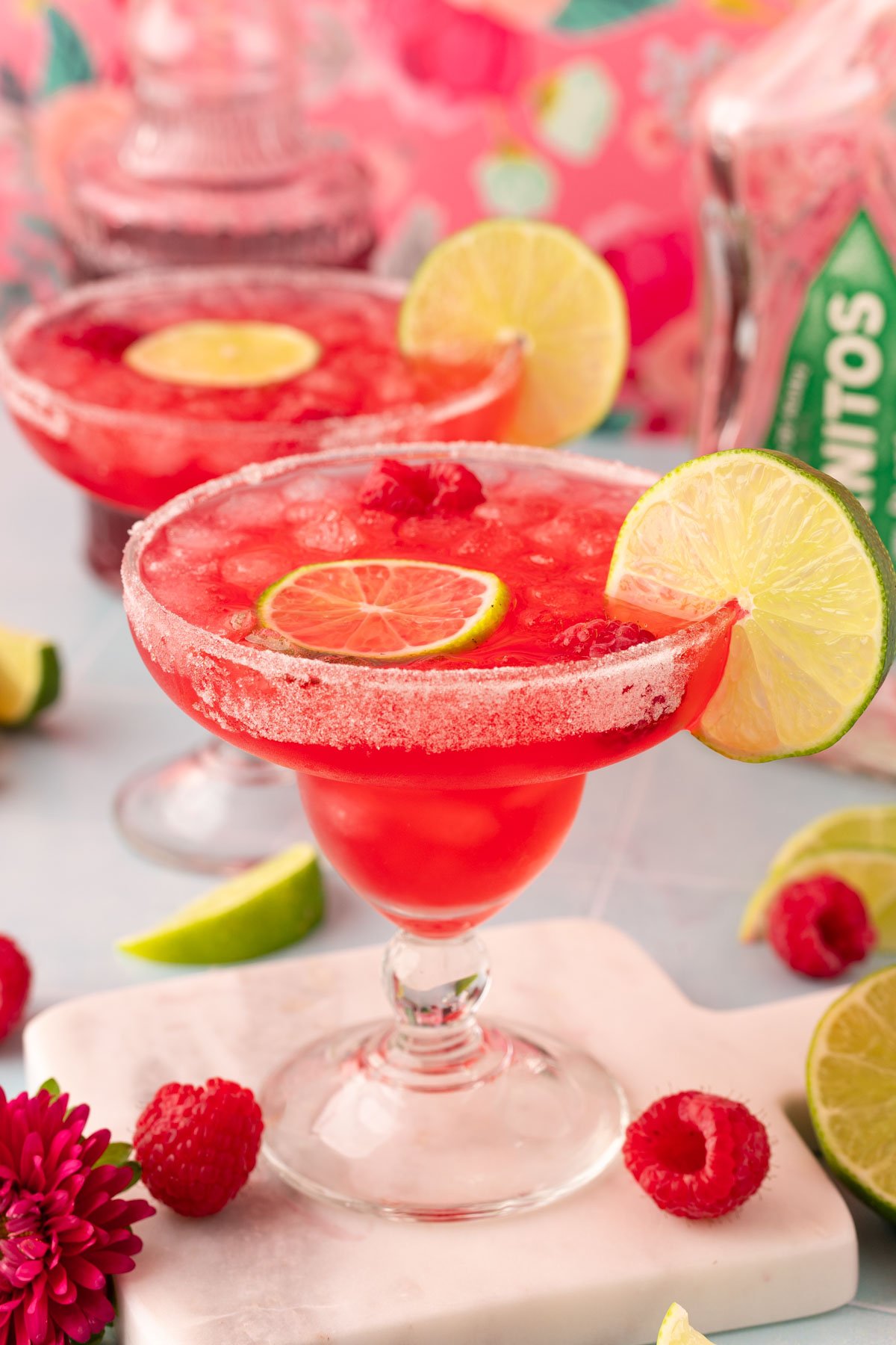 Raspberry margarita on a marble coaster.