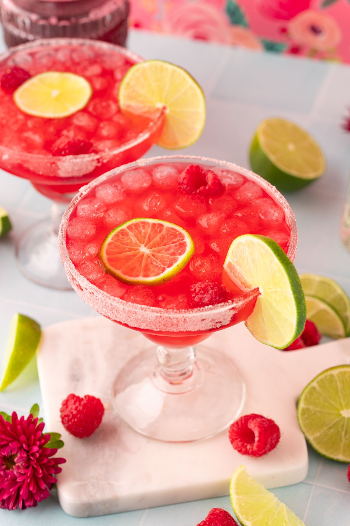 Raspberry margarita on a marble coaster.