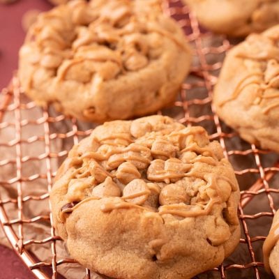 Thick Triple Peanut Butter Cookies on a copper wire rack.