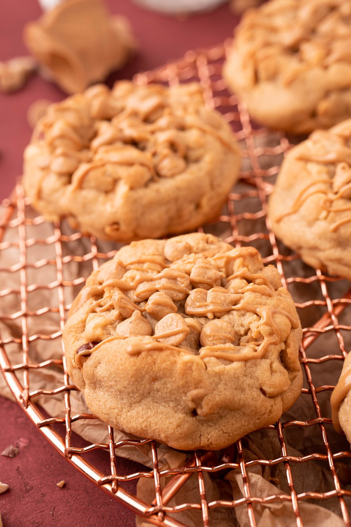 Thick Triple Peanut Butter Cookies on a copper wire rack.