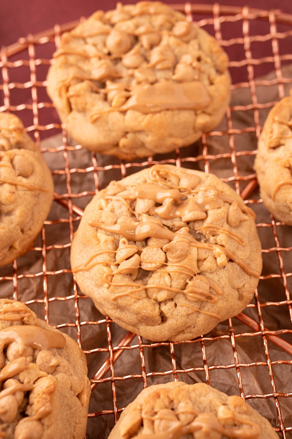 Peanut Butter Cookies made with nuts and peanut butter chips on a copper wire rack.