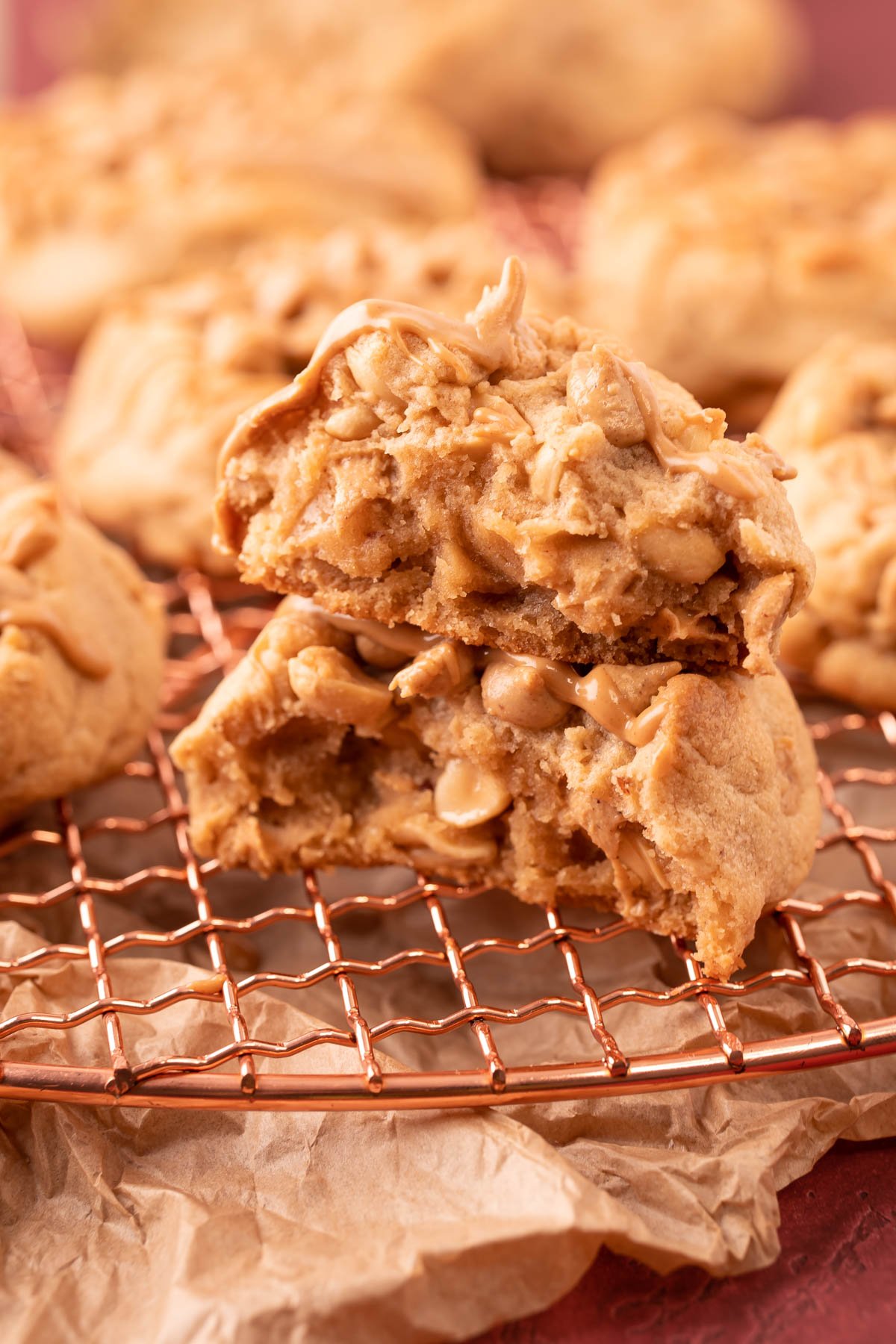 A thick triple peanut butter cookies that's been broken in half and the halves are stacked on top of each other.