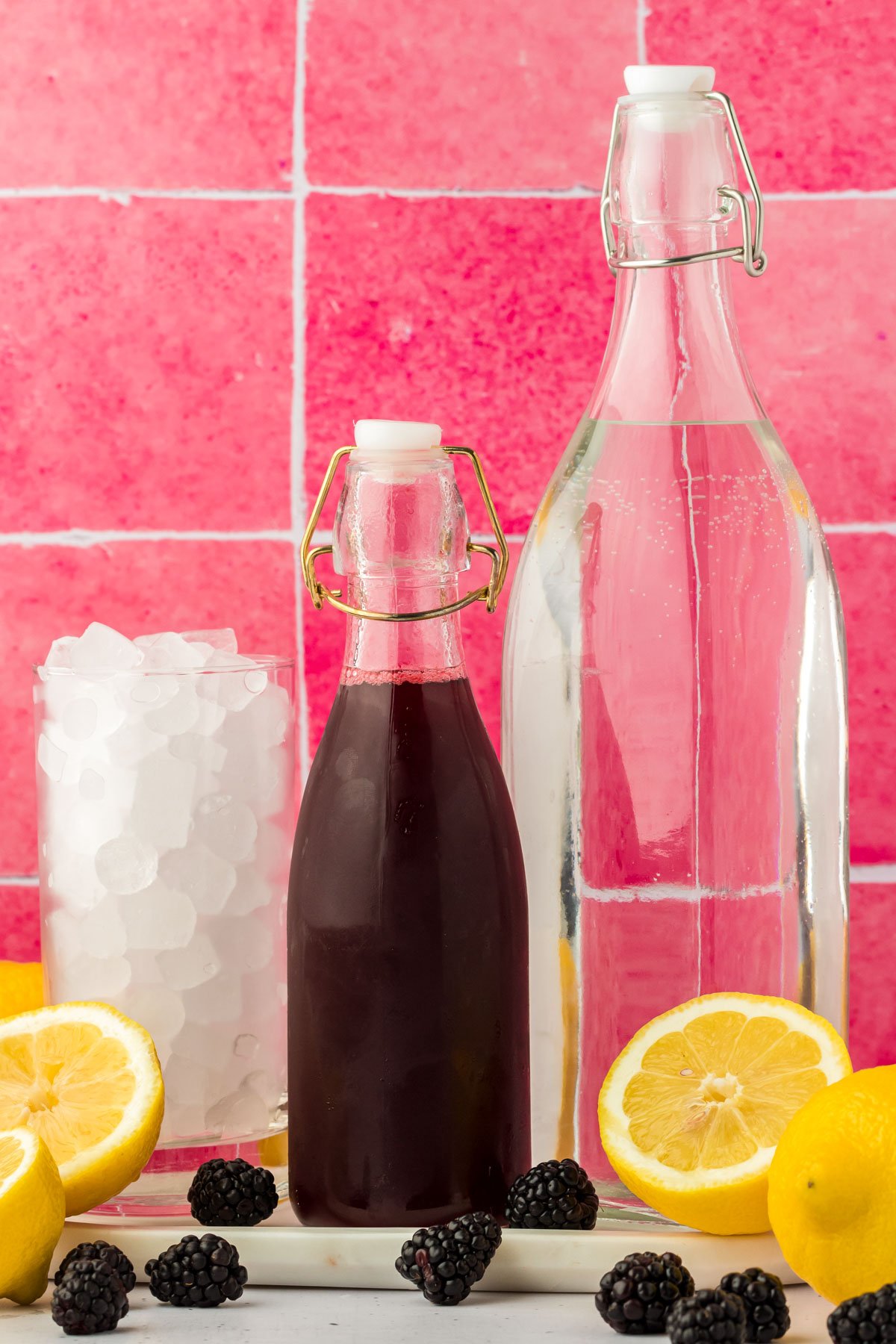 Ingredients to make blackberry lemonade on a counter.