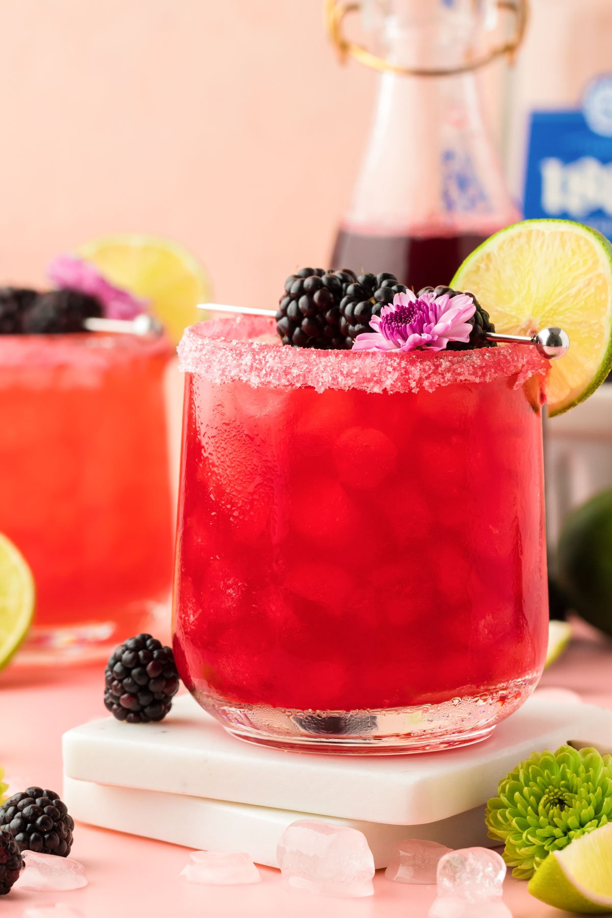 Two Blackberry Margaritas on a table.