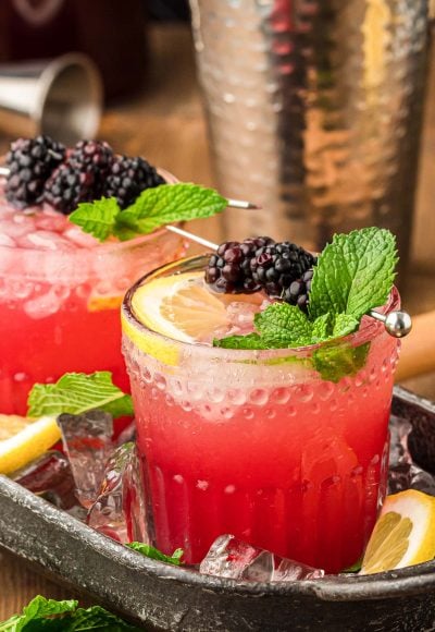 Blackberry Bourbon Smash in a black cocktail tray.