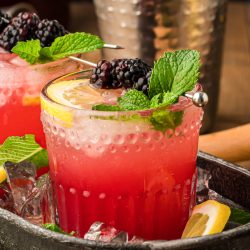 Blackberry Bourbon Smash in a black cocktail tray.