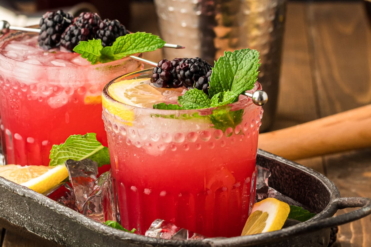 Blackberry Bourbon Smash in a black cocktail tray.