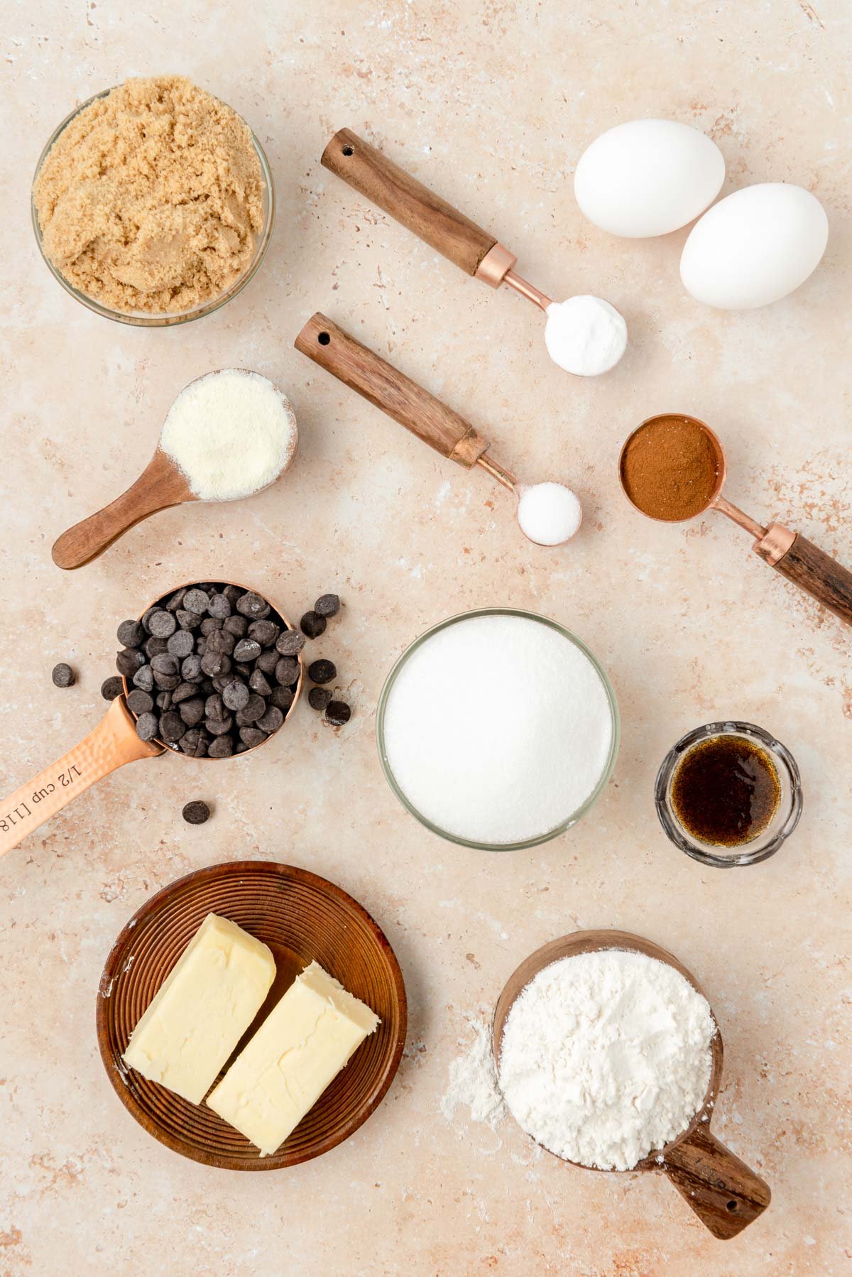 Overhead photo of the ingredients used to make cinnamon chocolate chip cookies on a table.
