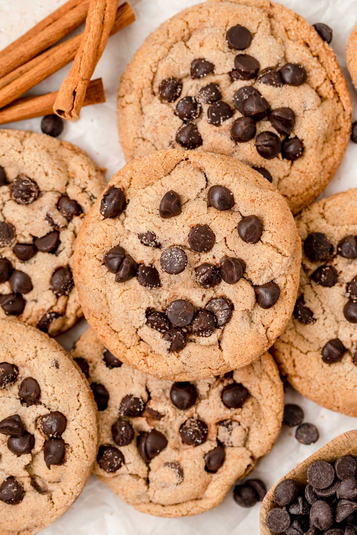 Overhead photo of chocolate chip cookies with cinnamon on a table.