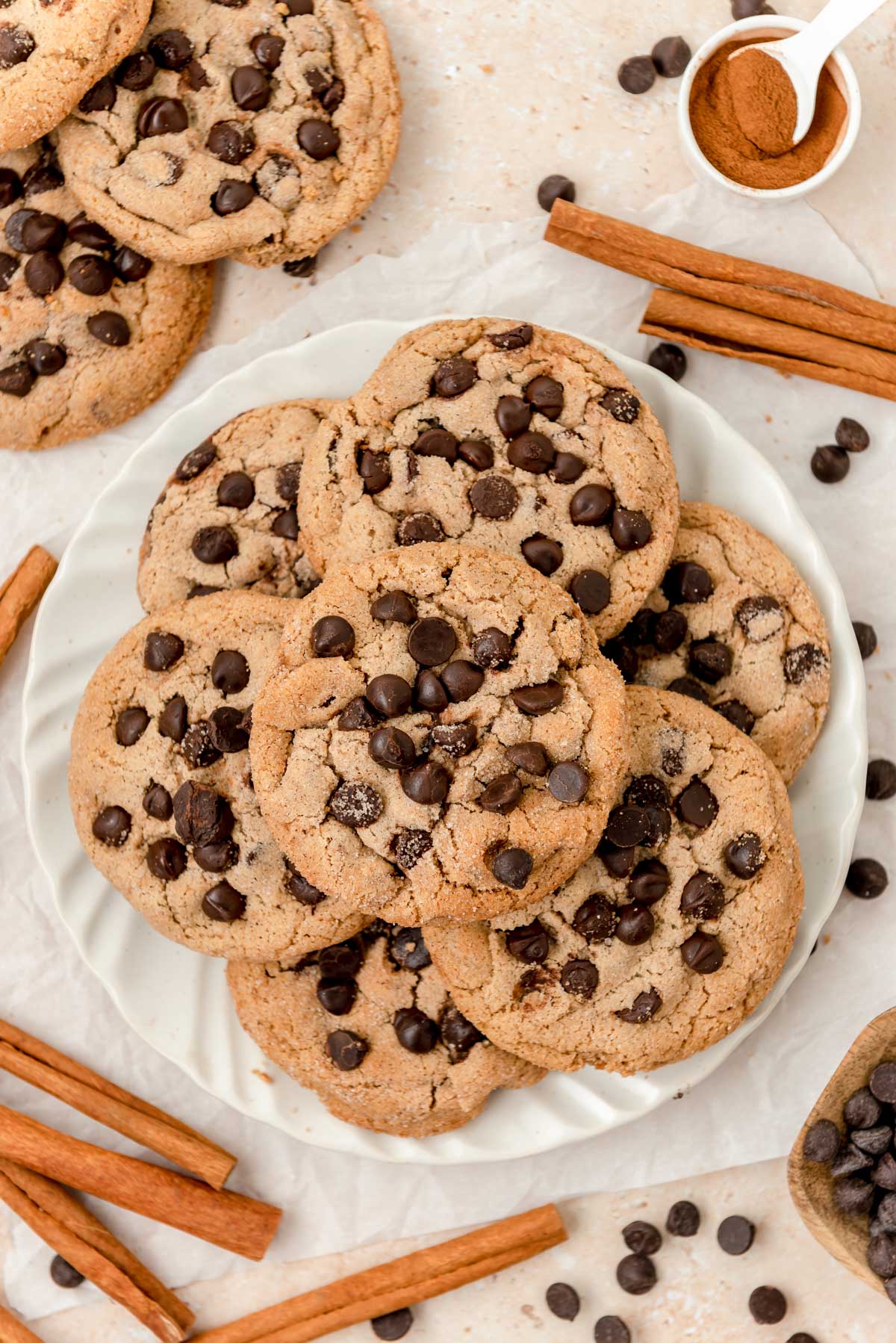 Cinnamon chocolate chip cookies on a white plate on a table.