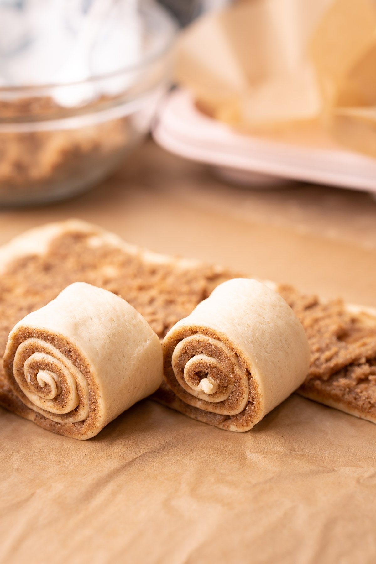 Cinnamon rolls being rolled up.