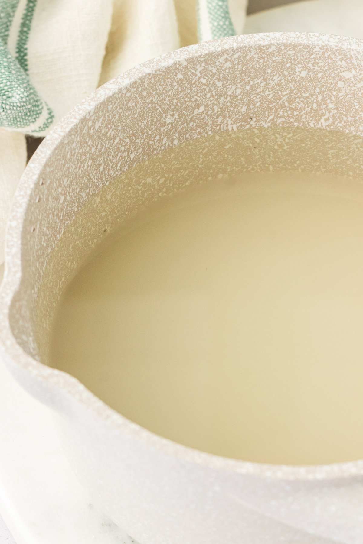 Sugar and water in a pot ready to make simple syrup.