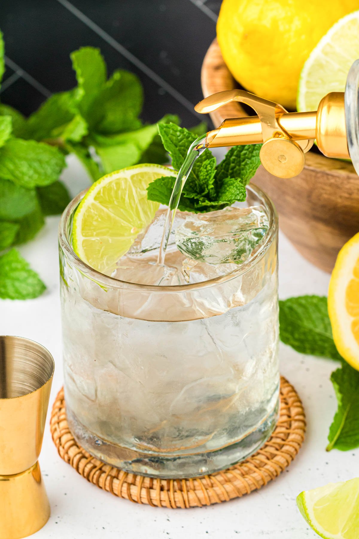 Simple syrup being poured into a cocktail.