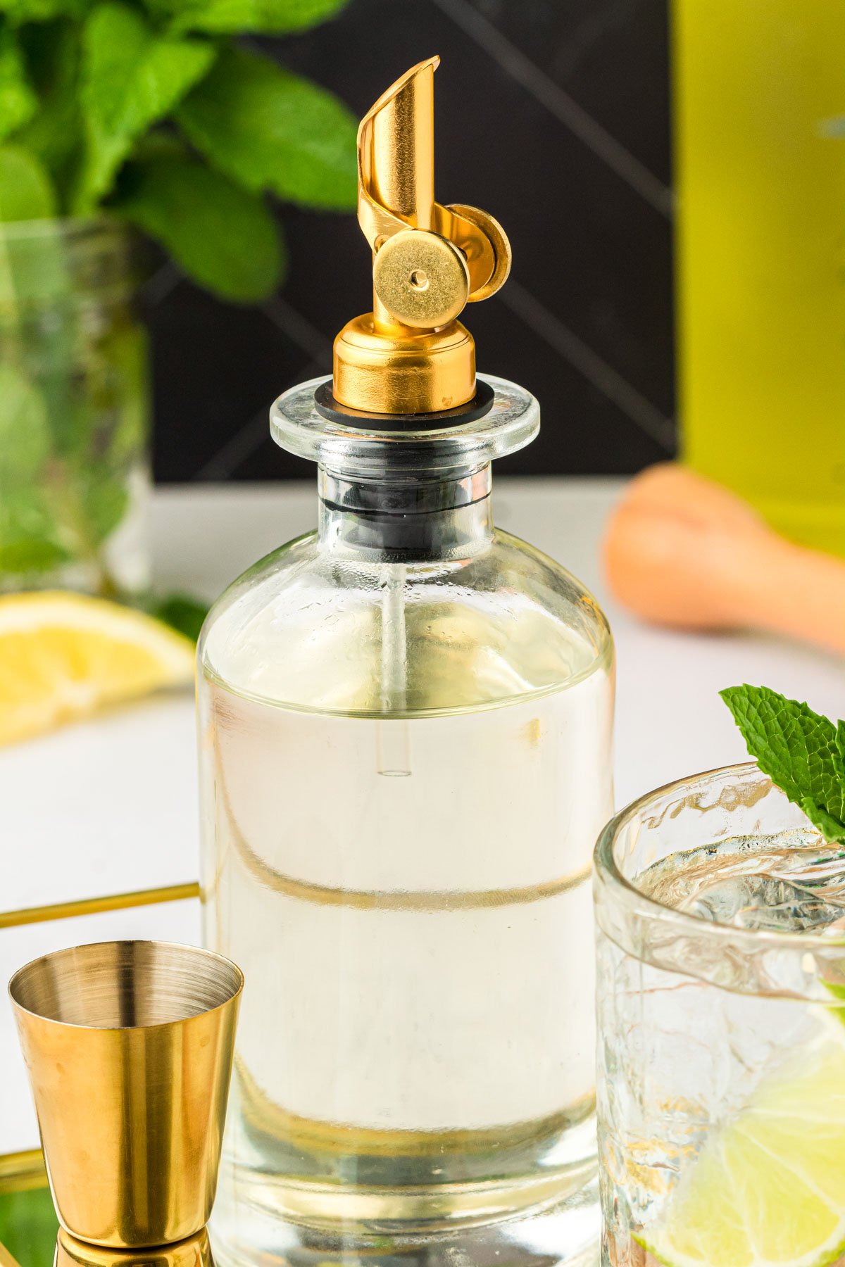 A bottle of homemade simple syrup on a bar.