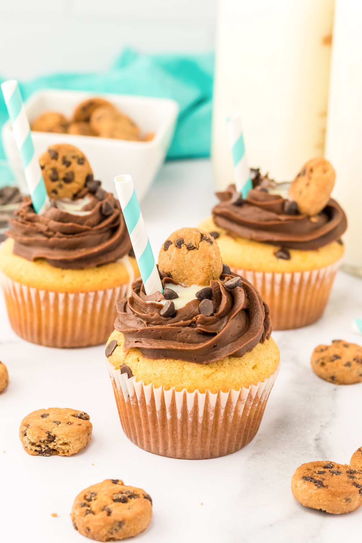 Milk and cookies cupcakes on a marble counter.