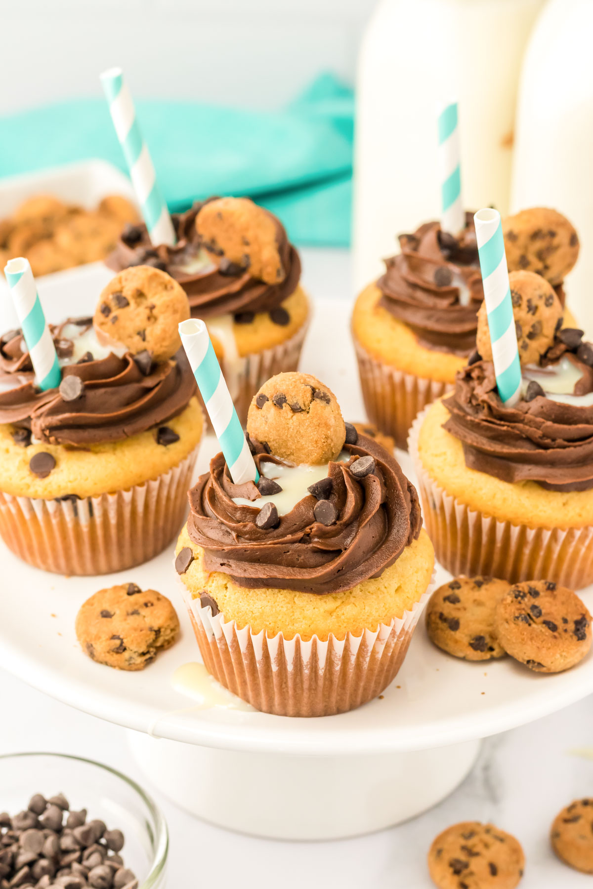 Milk and Cookies cupcakes on a white cake stand.