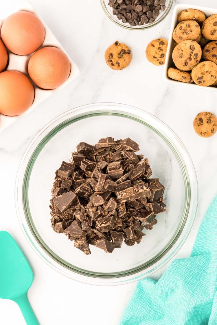 Chopped chocolate in a glass mixing bowl.