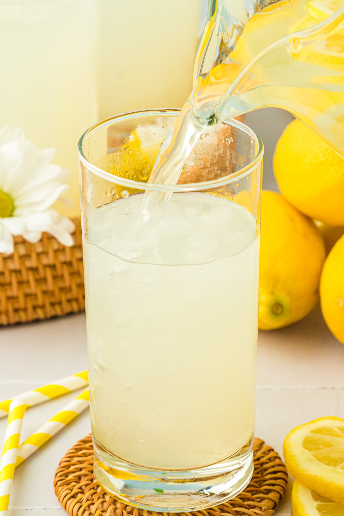 Lemonade being poured into a glass.