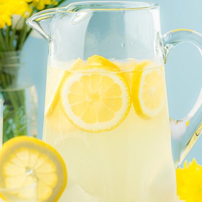 A large pitcher filled with lemonade.