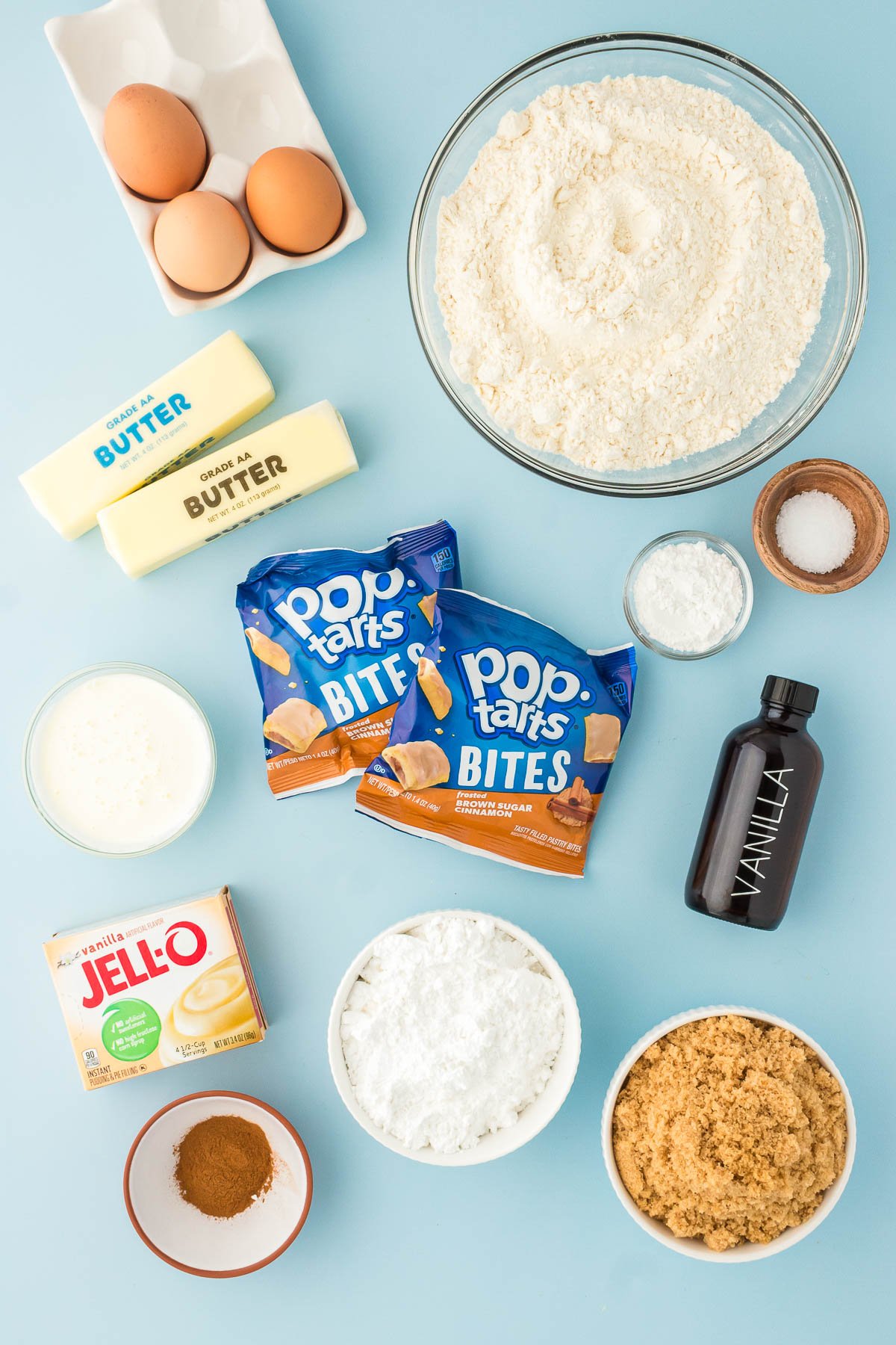 Ingredients to make Brown Sugar Cinnamon Pop Tart Cookies on a blue surface.